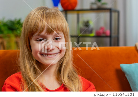 Portrait of happy smiling Caucasian preteen school girl child kid looking at camera, home play room Portrait of happy smiling Caucasian preteen school girl child kid looking at camera, home play room 110541301