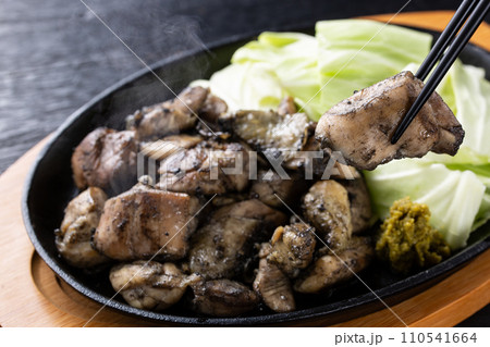 地鶏焼きを箸で食べる 110541664