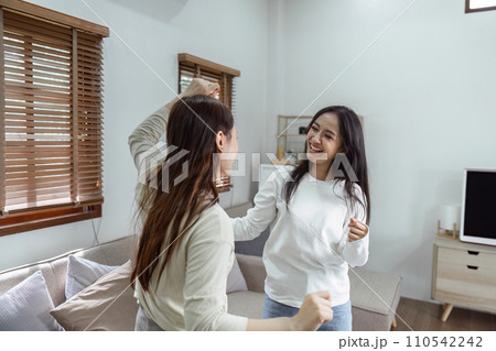 Young lesbian romantic couple in love dancing spending time together at home Young lesbian romantic couple in love dancing spending time together at home 110542242