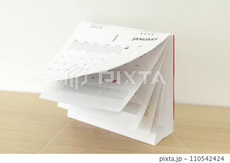 Calendar page flipping sheet on wood table background business schedule planning appointment meeting concept 110542424