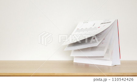 Calendar page flipping sheet on wood table background business schedule planning appointment meeting concept 110542426