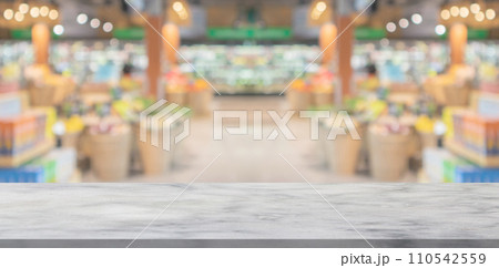 Empty marble table top with supermarket grocery store aisle and shelves blurred background Empty marble table top with supermarket grocery store aisle and shelves blurred background 110542559