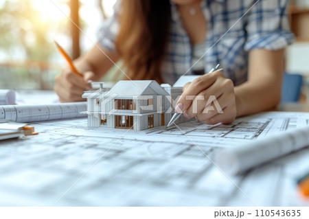 AI-generated content. Architects working with blueprint and mockup house. Generative AI 110543635