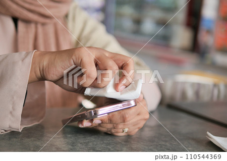 women cleaning mobile phone display for preventing virus women cleaning mobile phone display for preventing virus 110544369