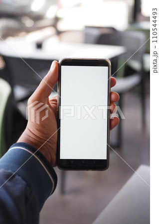 young man hand using smart phone with white screen at cafe  110544493