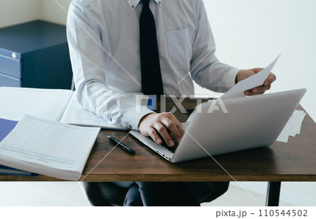 帳簿を確認する男性ビジネスマンの手元 帳簿を確認する男性ビジネスマンの手元 110544502