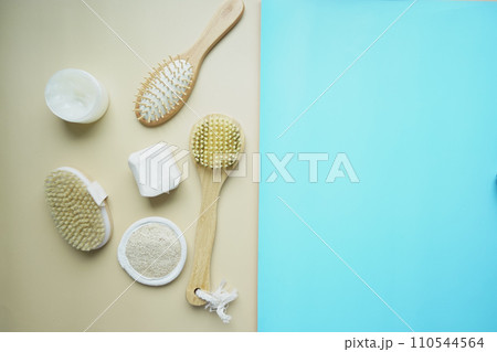 Clean towels, massage brush and bar of soap on table . 110544564