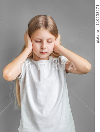 Little girl holding her head. 110552371