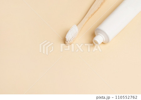 Blank white tube of toothpaste and wood brush on beige background, copy space Blank white tube of toothpaste and wood brush on beige background, copy space 110552762