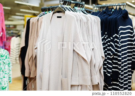Stylish clothes on hangers in the store Stylish clothes on hangers in the store 110552820