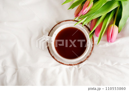 Morning breakfast in bed with coffee cup and pink tulips flowers Morning breakfast in bed with coffee cup and pink tulips flowers 110553860
