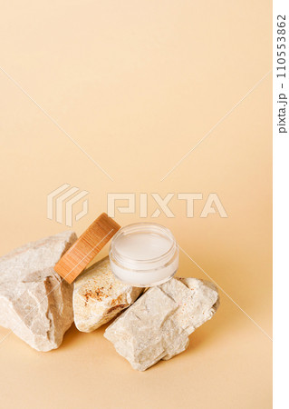 Cosmetic jar wooden lid with cream or lotion on stone podium for product presentation. Skincare cosmetic. yellow background. Beauty concept for face care 110553862
