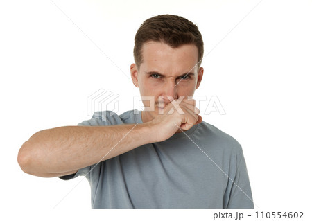 young man shows her toung, feels disgust on white background. 110554602