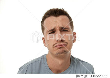 Portrait of offended frustrated young man on white background. sadness Portrait of offended frustrated young man on white background. sadness 110554607