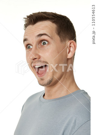 surprised guy looking at camera on white studio background 110554613