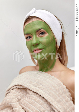beautiful woman with green alginate mask on face 110554827
