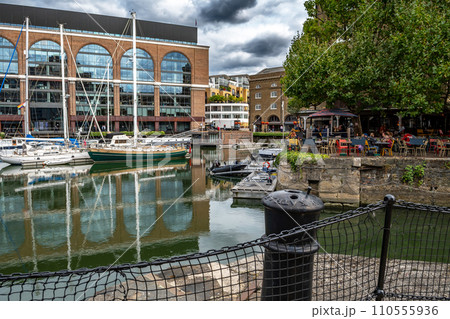 Boats And Ships In St Katharine Docks With Office Buildings And Restaurants In London, United Kingdom Boats And Ships In St Katharine Docks With Office Buildings And Restaurants In London, United Kingdom 110555936