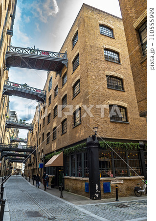 Shad Thames Buildings And Luxury Apartments With Cobblestone Alley Near Tower Bridge In London, United Kingdom Shad Thames Buildings And Luxury Apartments With Cobblestone Alley Near Tower Bridge In London, United Kingdom 110555999