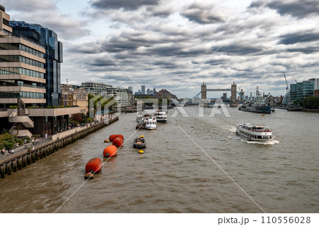 River Thames With Tower Bridge And Warship Belfast In Front Of London Skyline With Modern Skyscrapers In The United Kingdom 110556028