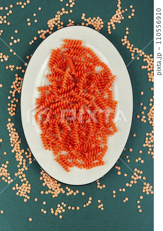 Raw orange spiral noodles. Raw orange spiral noodles. 110556910