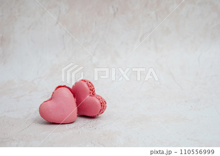 Heart shaped cookies pink macaroons on light concrete background with copy space Heart shaped cookies pink macaroons on light concrete background with copy space 110556999