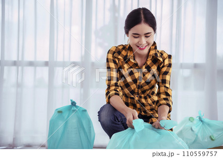Women sort plastic bottle and tie plastic bag to reuse and recycling for conservation environment 110559757
