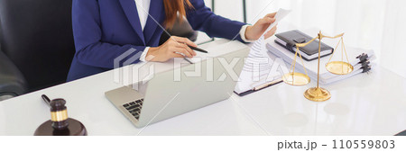 Lawyer woman reading business contract and checking document about legal agreement in legal office 110559803