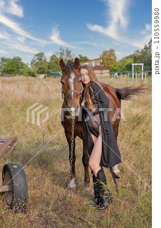 Beautiful caucasian woman in black bodysuit with horse Beautiful caucasian woman in black bodysuit with horse 110559980