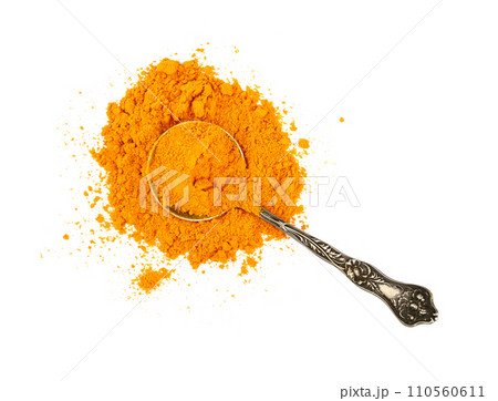 Metal spoon full of yellow turmeric powder Metal spoon full of yellow turmeric powder 110560611