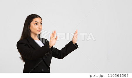 Confident caucasian businesswoman touching something invisible with her hands, free space, panorama 110561595