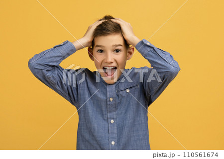 Wow. Portrait Of Shocked Teen Boy Touching Head And Looking At Camera 110561674