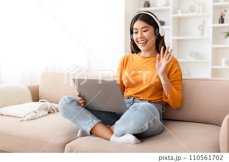 Positive chinese lady have online meeting with family, home interior 110561702