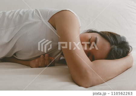 Woman fall asleep on the sofa as she tired and sick. Woman fall asleep on the sofa as she tired and sick. 110562263