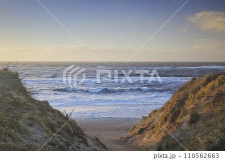 Stormy northern sea at sunset in Denmark. Coastal city Hvide Sande  110562663