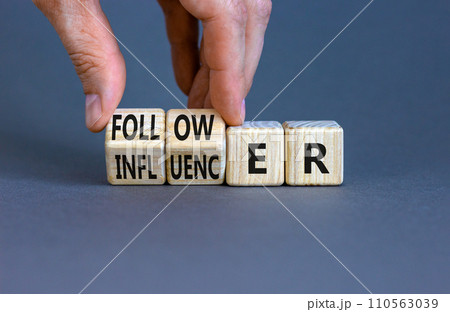 Follower or influencer symbol. Concept words Follower Influencer on wooden cubes. Beautiful grey table grey background. Businessman hand. Business follower influencer concept. Copy space. 110563039