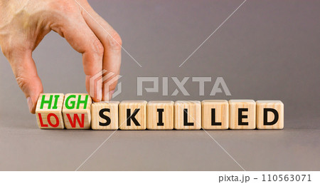 High or low skilled symbol. Concept words High skilled or Low skilled on beautiful wooden blocks. Beautiful grey background. Businessman hand. Business high or low skilled concept. Copy space. High or low skilled symbol. Concept words High skilled or Low skilled on beautiful wooden blocks. Beautiful grey background. Businessman hand. Business high or low skilled concept. Copy space. 110563071