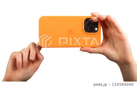 Berlin Germany December 21 2023 Hand holding iphone taking horizontal mobile photo isolated on white 110564040