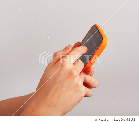 Hand holding mobile phone, smartphone, surfing internet, browsing online, scrolling social media 110564131
