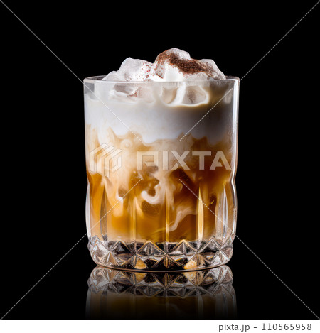 White Russian cocktail featuring layers of cream, coffee liqueur and vodka White Russian cocktail featuring layers of cream, coffee liqueur and vodka 110565958