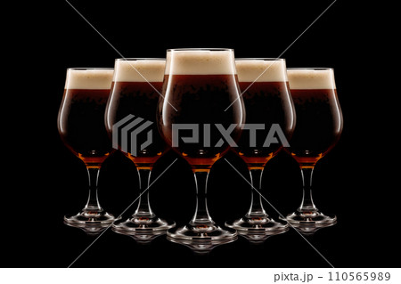 Set of Beer glasses on a black background. Mugs with drink like Ipa, Pale Ale, Pilsner, Porter or Stout 110565989