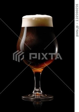 Beer in a tall glass on a dark black background. Mugs with drink like Ipa, Pale Ale, Pilsner, Porter or Stout 110566056