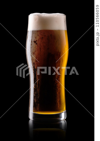 Beer in a tall glass on a dark black background. Mugs with drink like Ipa, Pale Ale, Pilsner, Porter or Stout 110566059
