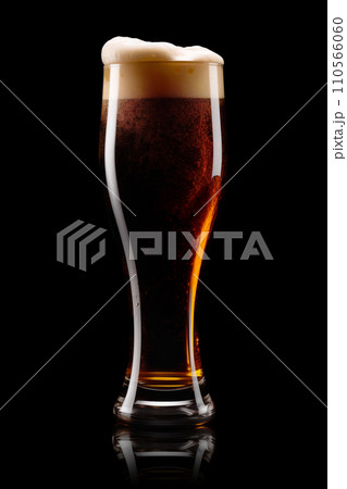 Beer in a tall glass on a dark black background. Mugs with drink like Ipa, Pale Ale, Pilsner, Porter or Stout 110566060