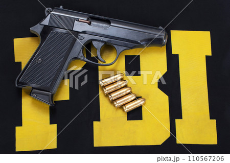 FBI concept with handgun and ammunition on black uniform 110567206