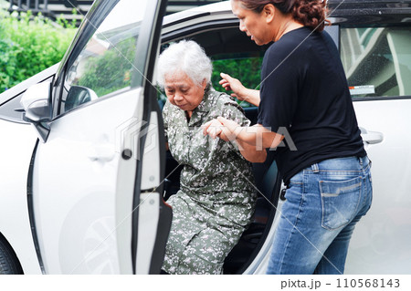 Caregiver help Asian elderly woman disability patient get in her car, medical concept. Caregiver help Asian elderly woman disability patient get in her car, medical concept. 110568143
