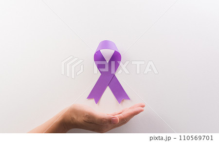 Hand holding purple ribbon on white background for supporting World Cancer Day campaign on February 4. 110569701