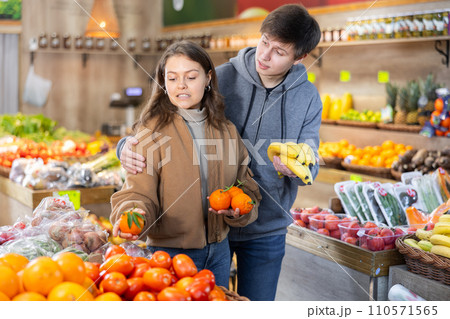 Happy married couple buying various fruits in grocery supermarket Happy married couple buying various fruits in grocery supermarket 110571565