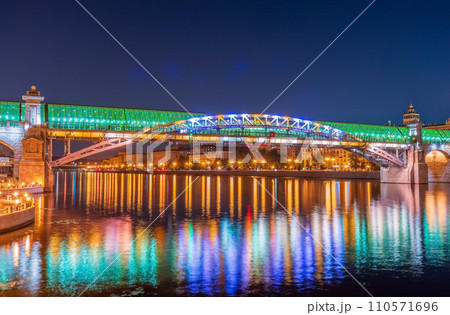 Pushkinskiy bridge with night illumination. Bridge to Gorky Park. Pushkinskiy bridge with night illumination. Bridge to Gorky Park. 110571696