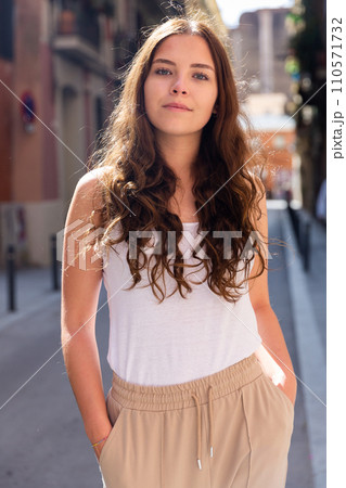 Cheerful attractive female walking on street outdoor 110571732
