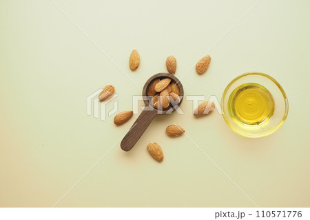almond oils and fresh nuts on table almond oils and fresh nuts on table 110571776